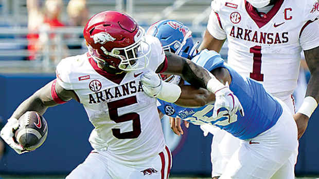 Arkansas Razorbacks running back Raheim Sanders (5) is grabbed from behind by Mississippi Rebels defensive lineman Tavius Robinson (95) at Vaught-Hemingway Stadium.